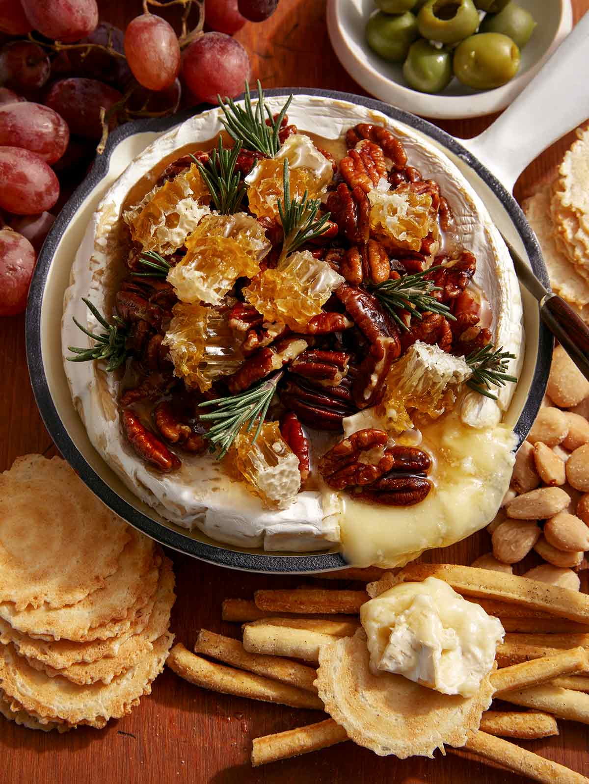 Baked brie recipe with crackers and grapes on the side. 