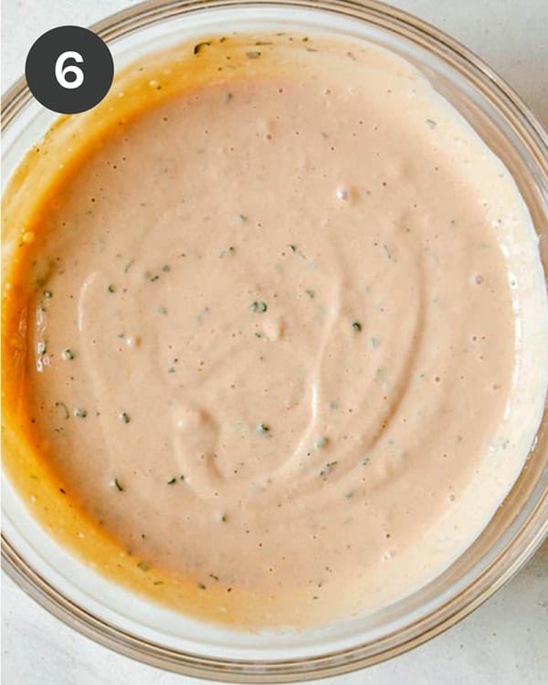 Combined ingredients in a bowl to make BBQ Yogurt Ranch Dressing.