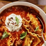 Two bowls of lasagna soup up close.