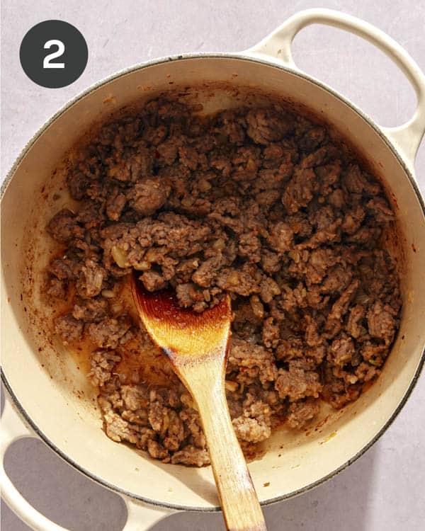 Onion and meat cooking in a pot to make a soup. 