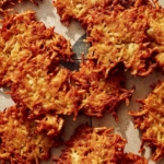 Close up on potato latkes with crispy edges.