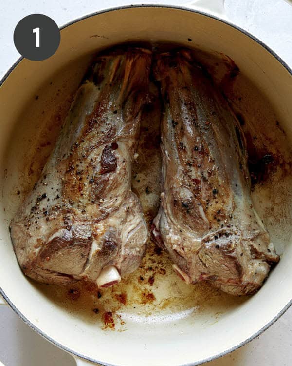 Sear lamb shanks in a stock pot.