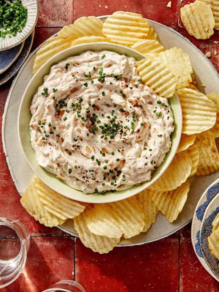 French onion dip recipe in a bowl with chips on the side.