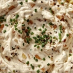 French onion dip in a bowl with chips on the side.