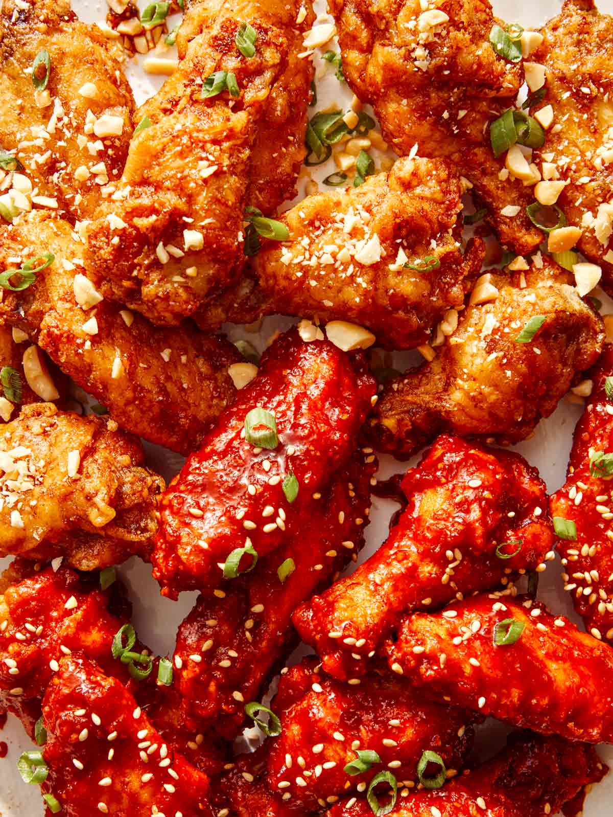 Close up on a platter of Korean fried chicken with two different sauces.