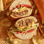 Chopped cheese sandwich with chips on the side.