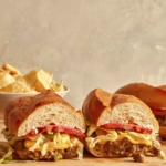 Chopped cheese sandwich on a cutting board.
