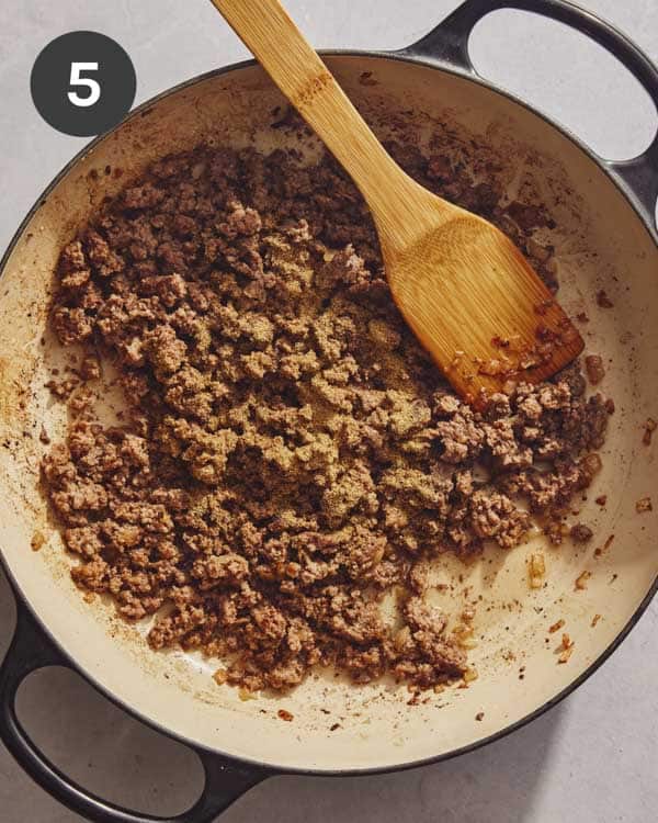 Ground beef in a skillet with seasonings.