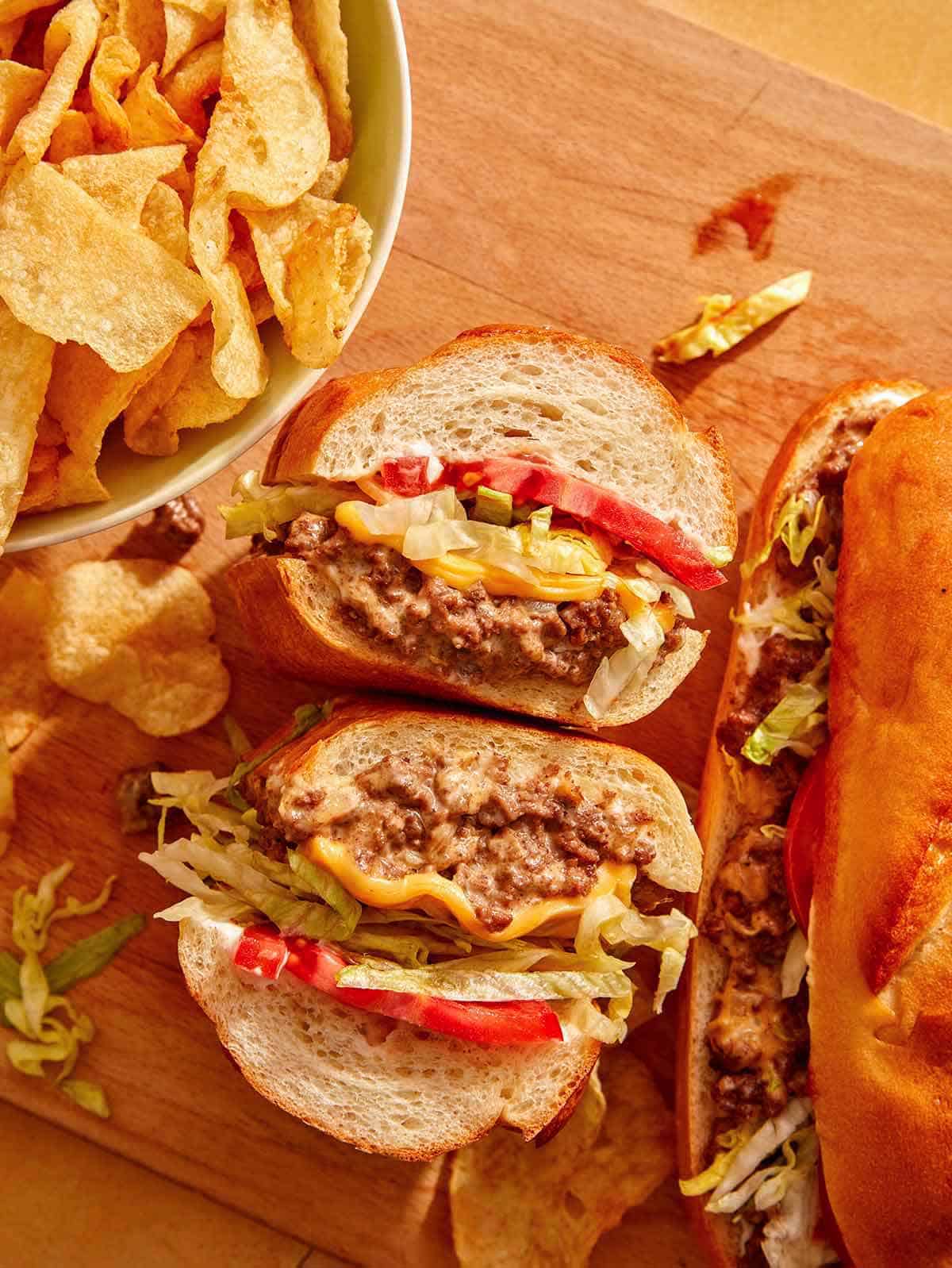 Chopped cheese sandwich with chips on the side.