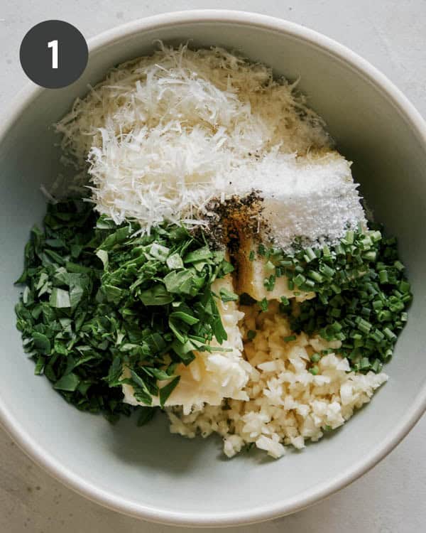 Garlic bread spread ingredients added into a bowl.