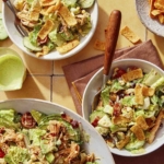 Southwest cobb salad mixed and served into bowls.