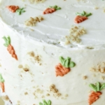 Close up on carrot cake with frosting.