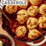 Chili Cornbread Casserole in a skillet with a scoop taken out.