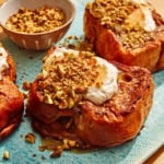 French toast on a platter with nuts on the side.