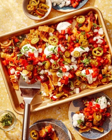 Frito pie recipe on a baking sheet being served.
