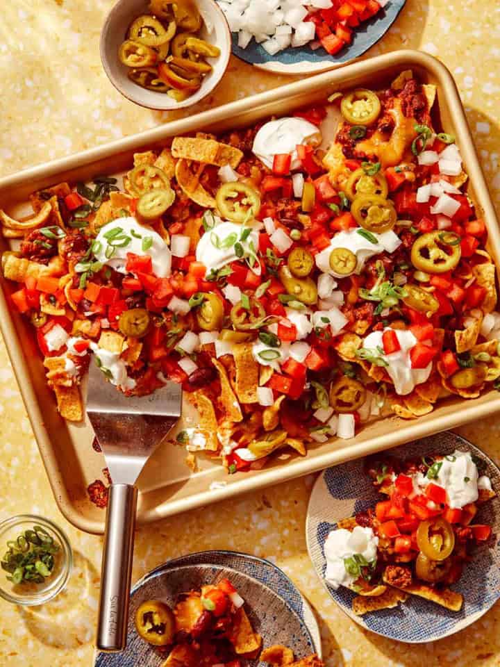 Frito pie recipe on a baking sheet being served.