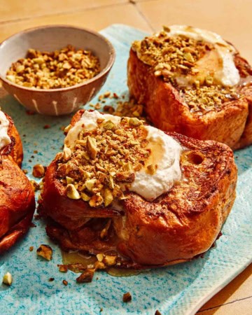 French toast on a platter with nuts on the side.