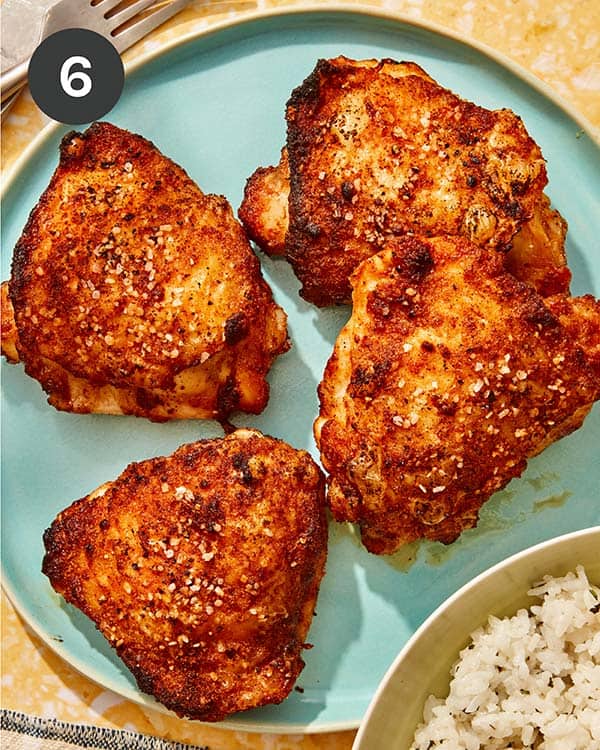 Chicken thighs made in an air fryer on a platter.