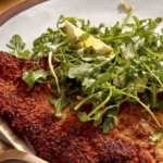 Chicken milanese recipe on a dinner plate.