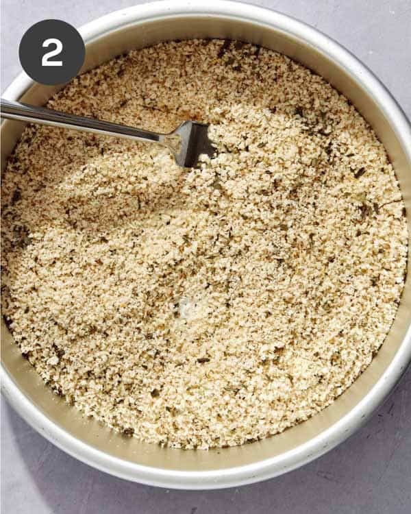 Breading mixed together in a shallow bowl for chicken milanese.