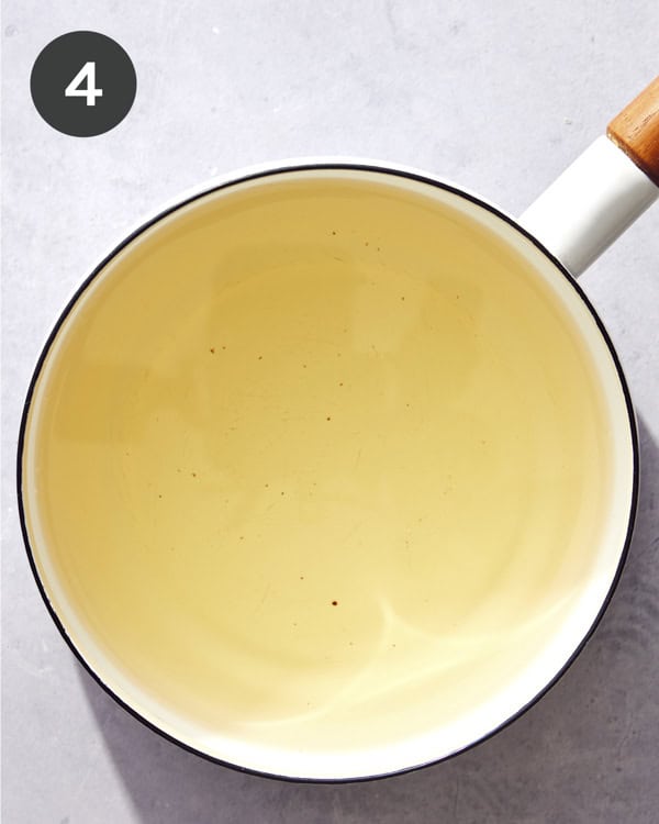 Oil used to fry shallots in a pot.
