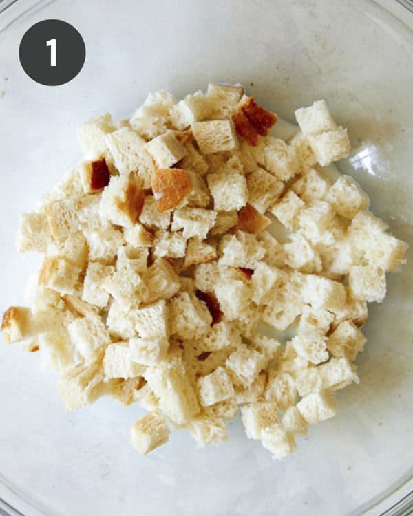 Cubed white bread soaking in milk.