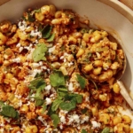 Close up on a bowl of Mexican street corn salad.