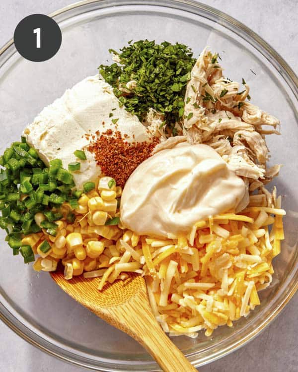 Taquito filling in a glass bowl about to be mixed.