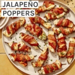 Bacon wrapped jalapeno poppers on a platter with some being served onto plates.