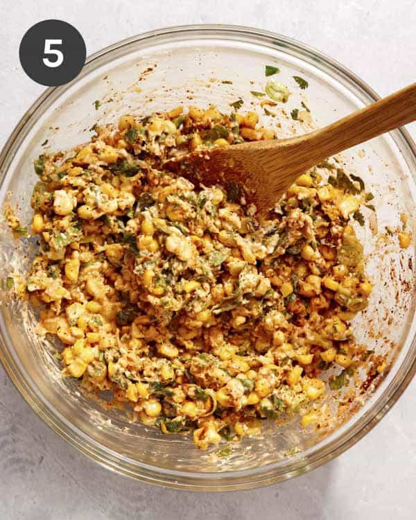 Mexican street corn salad in a bowl with a spoon.