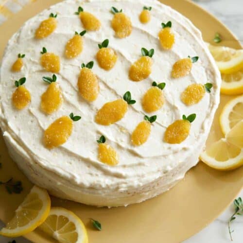 Whole lemon thyme cake garnished with lemon slices.