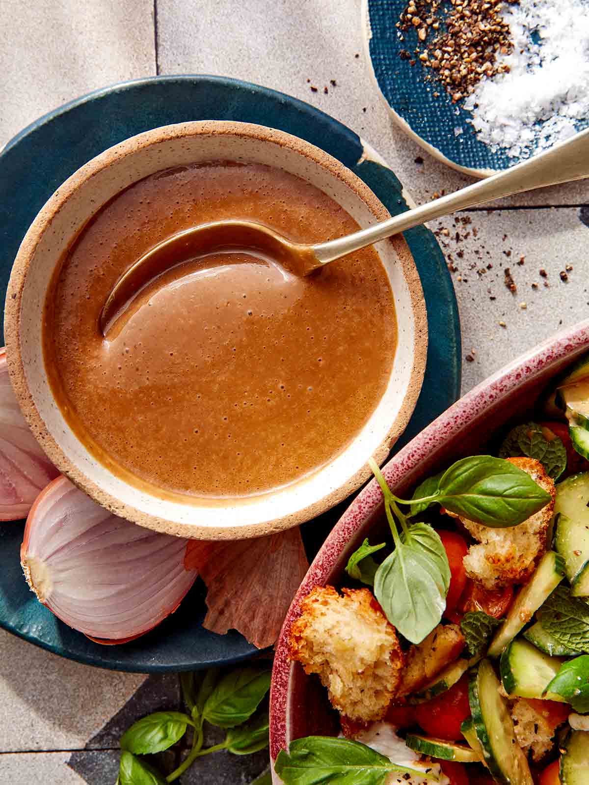 Balsamic Vinaigrette recipe in a bowl with a spoon with ingredients around it.