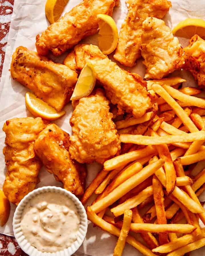 Beer battered fish with french fries and tartar sauce ready to be eaten.