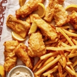 Beer battered fish with french fries and tartar sauce ready to be eaten.