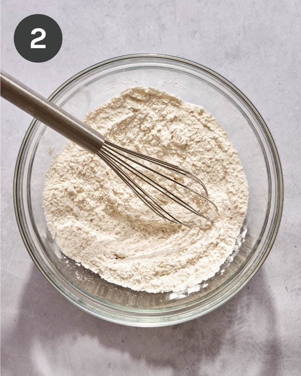 Dry mixture in a bowl with a whisk to make beer battered fish.