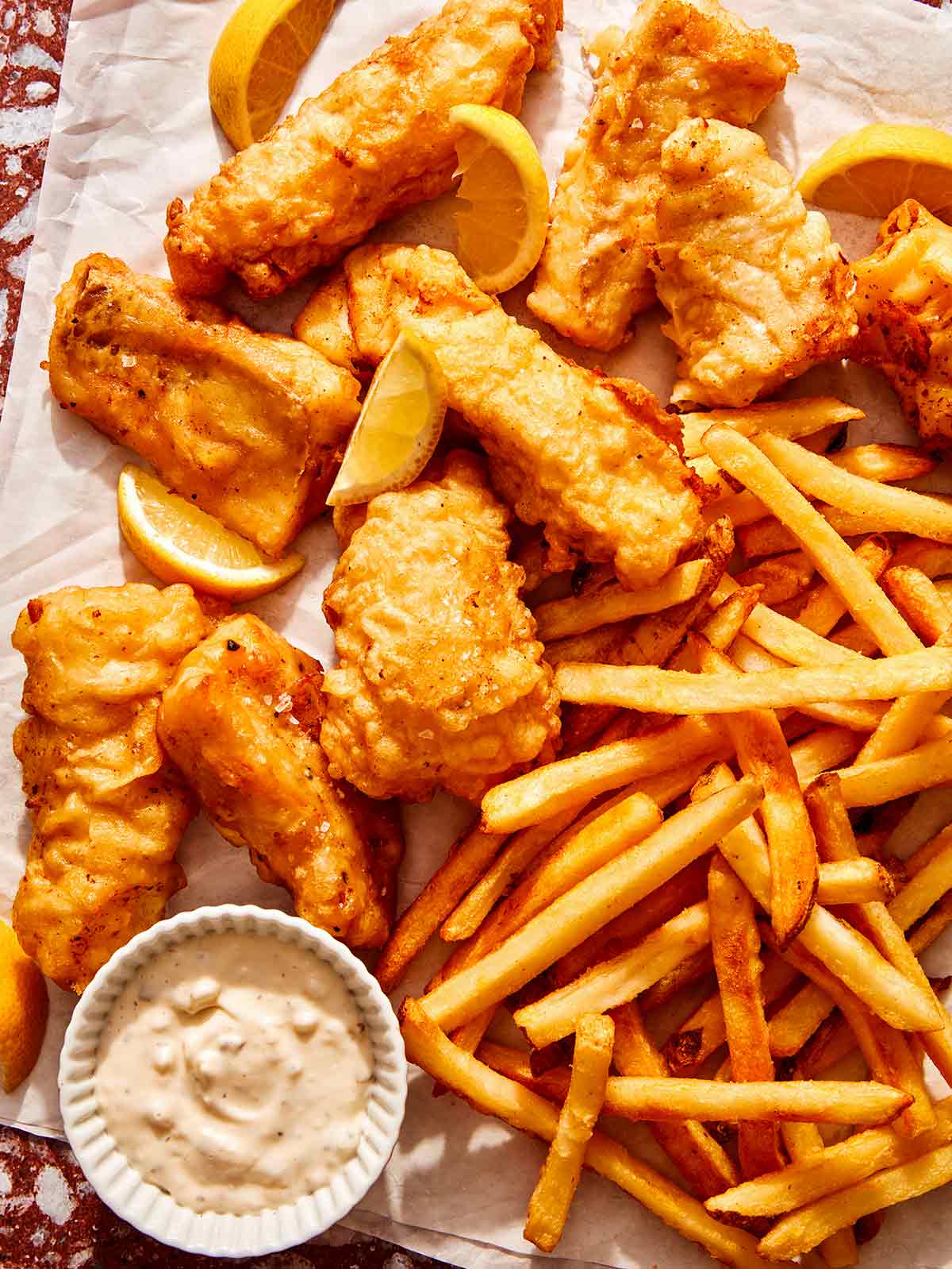 Beer battered fish with french fries and tartar sauce ready to be eaten.