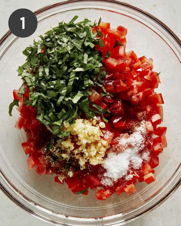 Bruschetta ingredients in a bowl ready to be mixed.