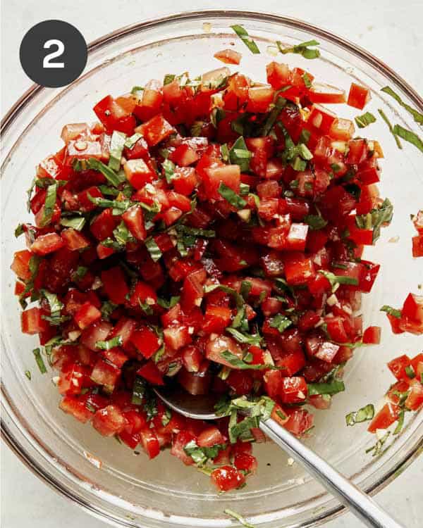 Bruschetta ingredients mixed together in a bowl. 
