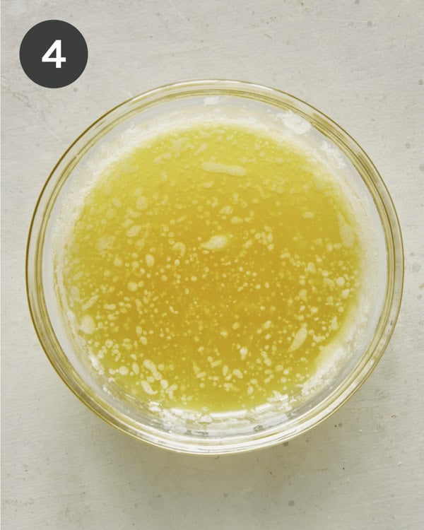Mixing together butter and oil for bruschetta crostini. 