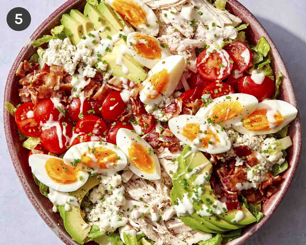 Cobb salad in a bowl with all the toppings.