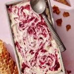 No churn ice cream in a loaf pan with a scoop on top.