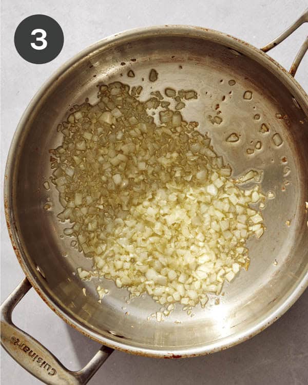 Garlic cooking in a pan with hot oil.