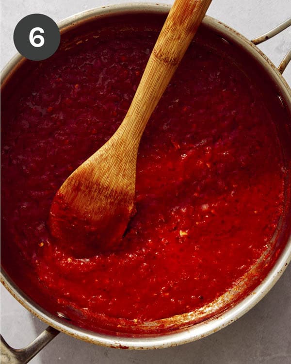 Tomato sauce being cooked down in a pan.