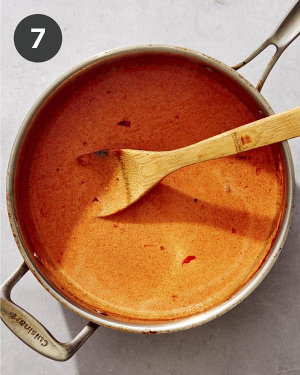 Creamy tomato sauce being cooked in a pan.