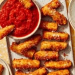 Fried zucchini on a platter being served to guests.
