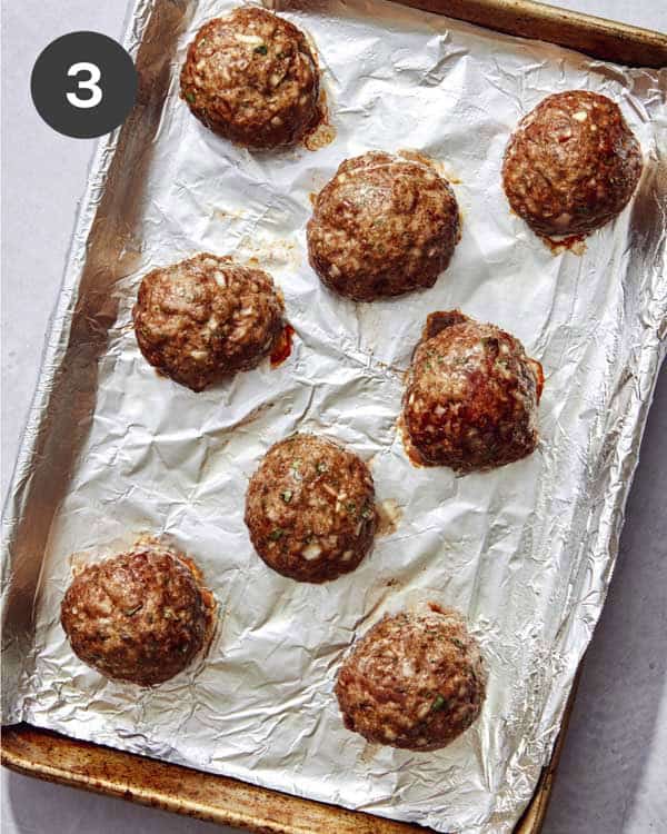 Meatballs on a baking sheet fresh out of the oven.