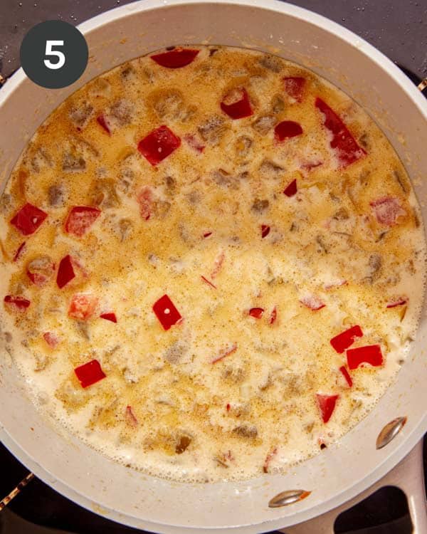 Evaporated milk mixed with cooked down vegetables to make a queso recipe.