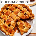 Brown butter apple pie recipe with a cheddar crust and a slice taken out.