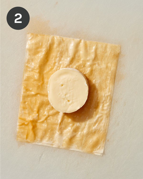 Phyllo squares with a mini brie wheel on top.