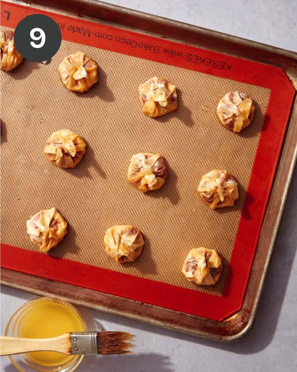 Freshly baked brie bites on a baking sheet.